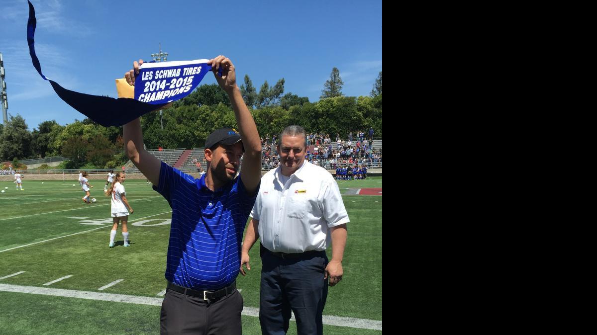 
Ripon Christian girls soccer coach Kevin Tameling showcases the Sac-Joaquin Section Division VII banner to fans after Ripon Christian defeated Forest Lake Christian 1-0 on Saturday, May 16, at Lincoln High in Stockton.
