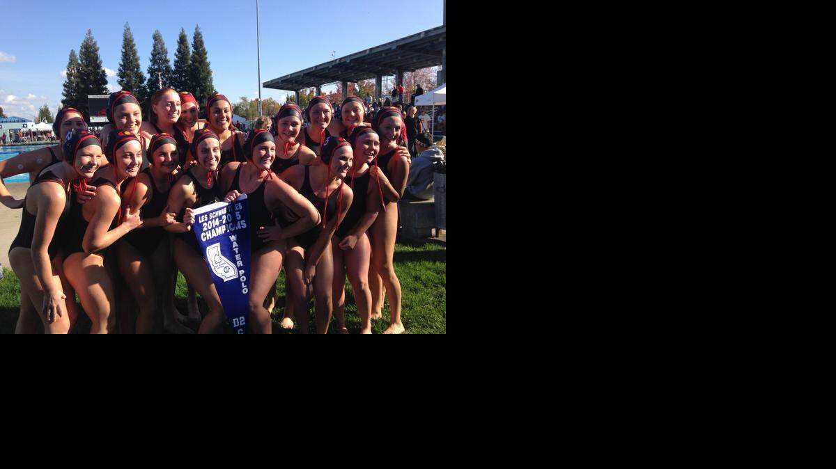 
Members of the Oakdale High girls water polo team celebrate with the Sac-Joaquin Section Division II banner on Saturday, Nov. 15, 2014.
