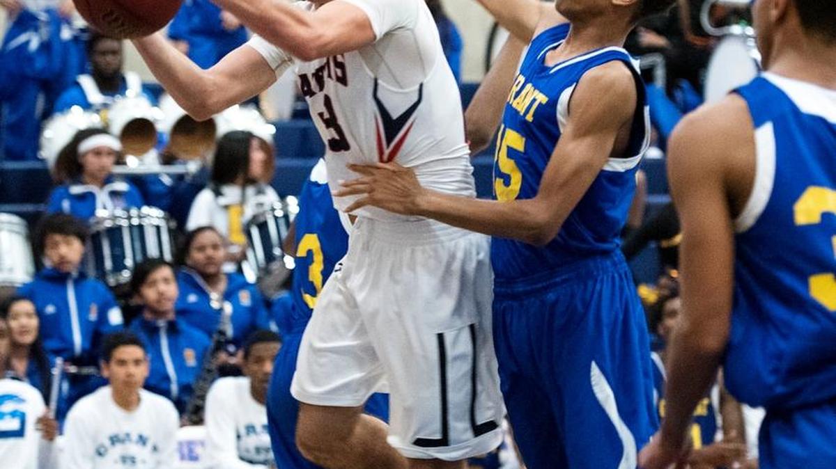 Beyer guard Brian Perry scores on a layup as Grant’s David Jones defends during the Sac-Joaquin Section Division II playoff game at Beyer High School in Modesto on Wednesday, Feb. 24, 2016. Grant won the game 67-57.