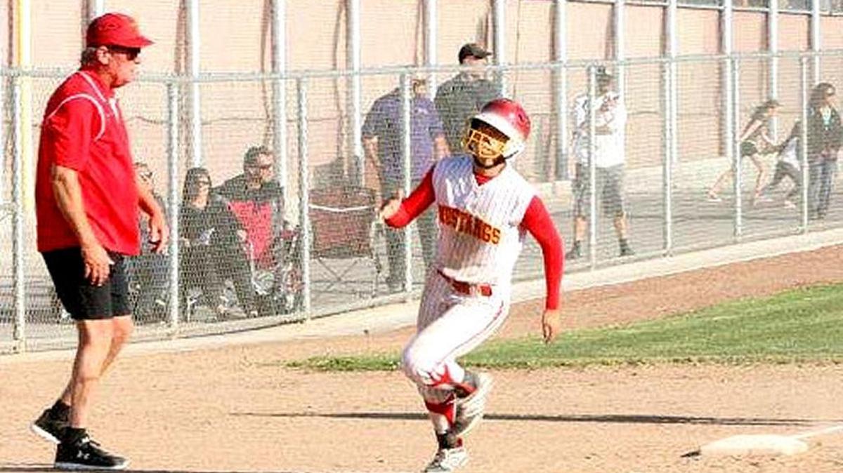 Oakdale High softball coach Larry Loger, shown here sending a runner home, has built his program from the youth level on up. Loger is in his 20th year as a board member of the Oakdale Baseball & Softball Association. Tuesday, March 15, 2016