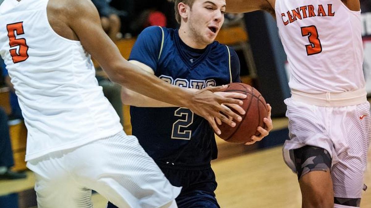 Central Catholic's Cooper Wilson drives between Central's Jahmai Bartley (5) and Cam'Ron Wilson (3) during the 17th Holiday Hoop Classic at Modesto Christian High School in Salida, Calif., on Tuesday, Dec. 27, 2016.