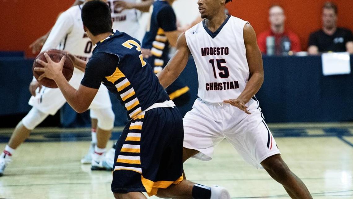 Modesto Christian's Emoni Karriem defends on Turlock's Arik Bains during the 17th Holiday Hoop Classic game at Modesto Christian High School in Salida, Calif., Wednesday, Dec. 28, 2016.