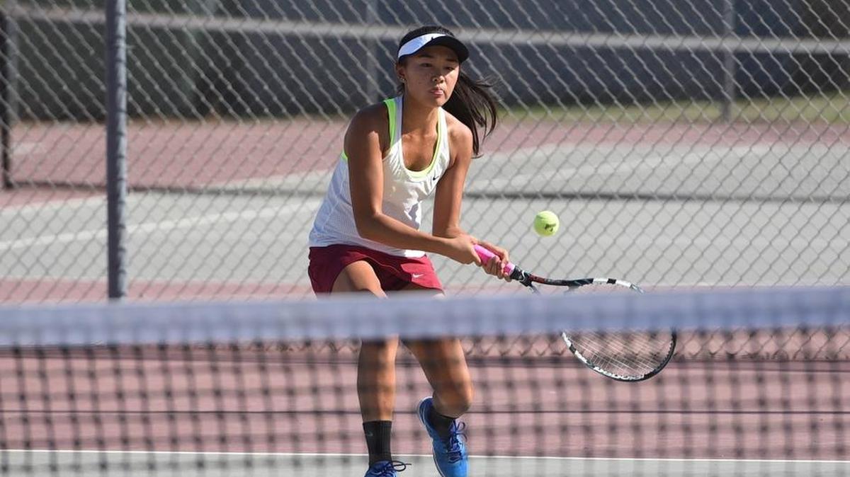 Los Banos’ Shirley Liu, shown here last season against Patterson, has played all four years for the Tigers to help the girls tennis team stretch their streak to 100 consecutive Western Athletic Conference wins.