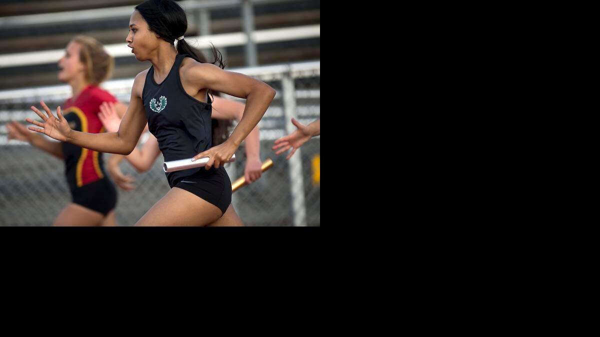 
Pitman junior Kiana Clay runs the second leg of the girls 4X100 race in the Stanislaus County Meet at Turlock High School in Turlock, Calif., on Friday, March, 13, 2015. Pitman won the race with a meet record time of 50.02.

