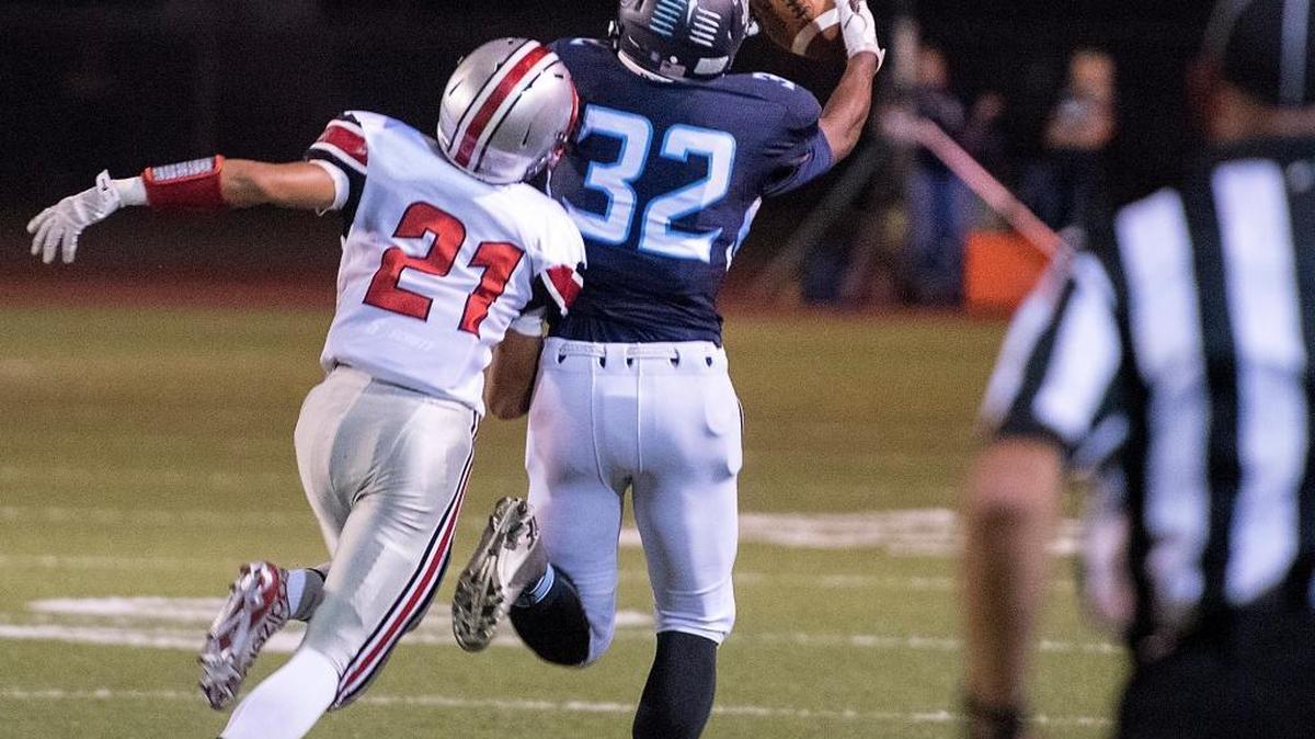 Downey’s Isaiah Johnson beats out Lincoln's Isaiah Downes for a large gainer during the non-conference game at Downey High School in Modesto Calif., on Friday, September, 18, 2015.