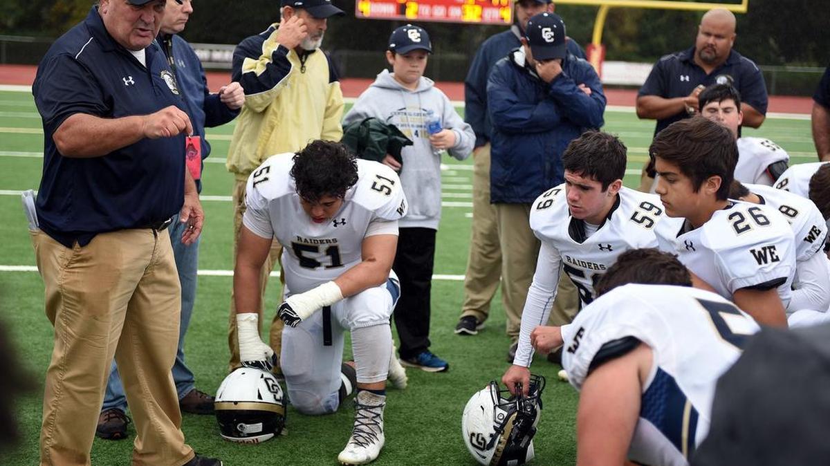 Central Catholic High School's head coach Roger Canepa (left) talks to his team Saturday (11-19-16) after their Sac-Joaquin Section Division ll loss to Jesuit High School at the Jesuit High School stadium in Carmichael, Calif.