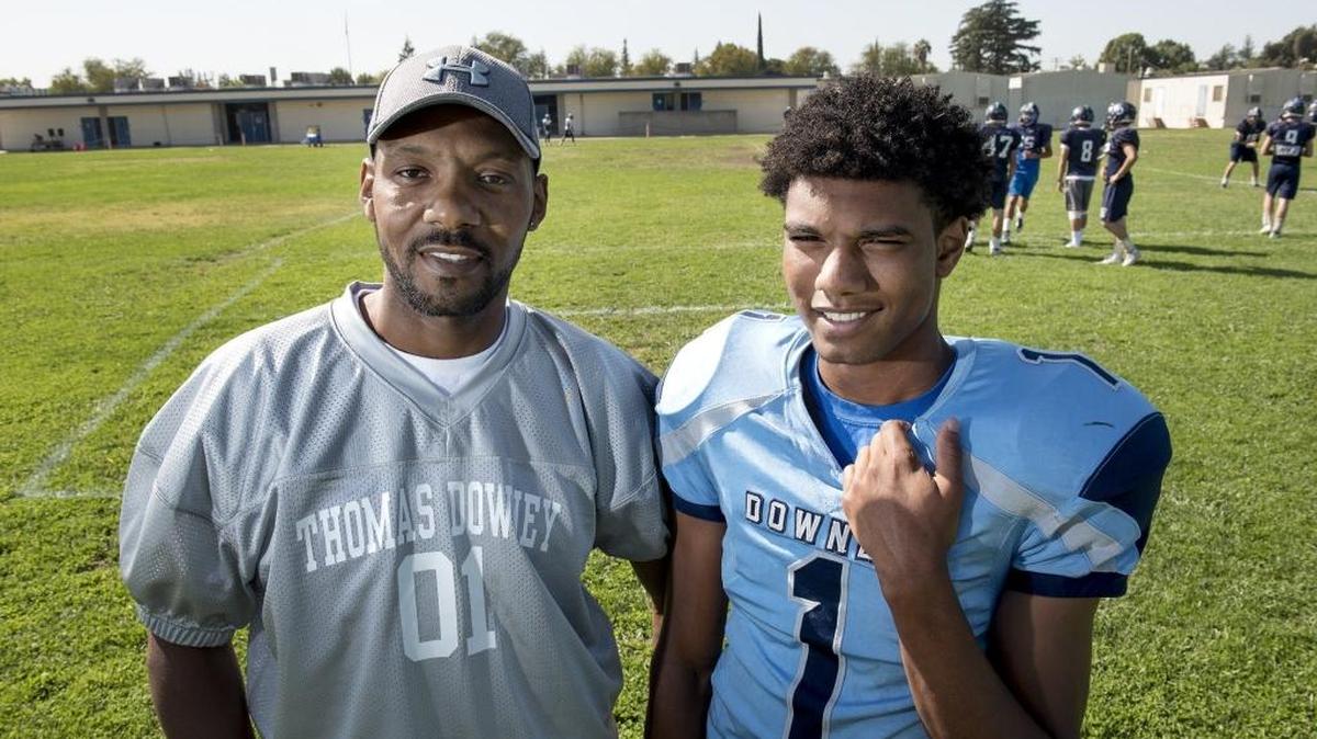 Jairol Red, left, and his son Jairol Harris-Red pose last week at Downey High. Since Red was diagnosed with cancer, sports has become a family haven. Red will join the basketball coaching staff to help guide his son this winter.