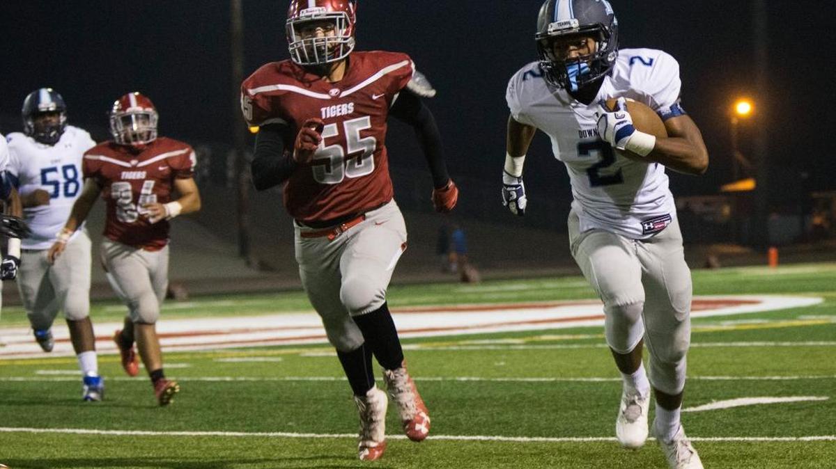 Javon Gamez, 2, of Downey High works his way up field with Patterson High’s Armando Robles closing in during the first half. Downey vs Patterson Sept. 1, 2017 at Patterson High.