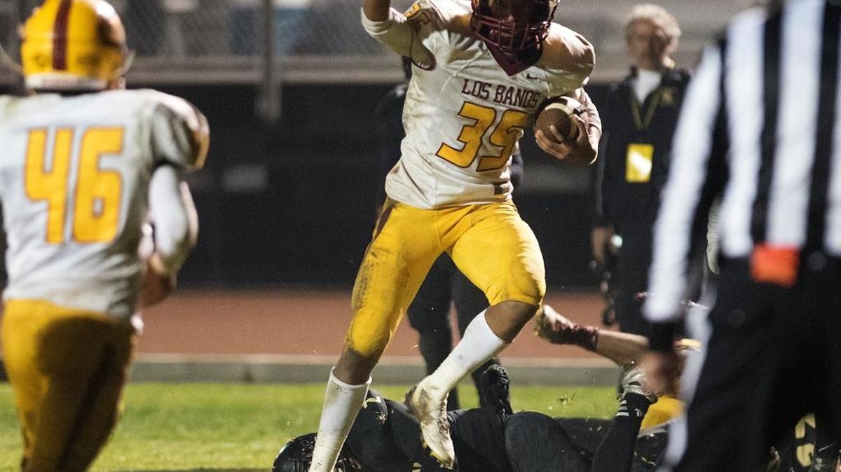 Los Banos' David Walker intercepts a pass in the fourth quarter during the first round D IV Sac-Joaquin Section game with Lathrop at Lathrop High School in Lathrop, Calif., on Friday, Nov. 13, 2015. Los Banos won the game 30-29.
