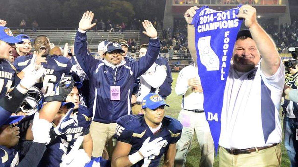 
Central Catholic Head Coach Rodger Canepa holds up the banner after winning the Sac-Joaquin Section Division IV Championship game defeating Sonora 42-35 at Stockon's Lincoln High School on November 28th.
