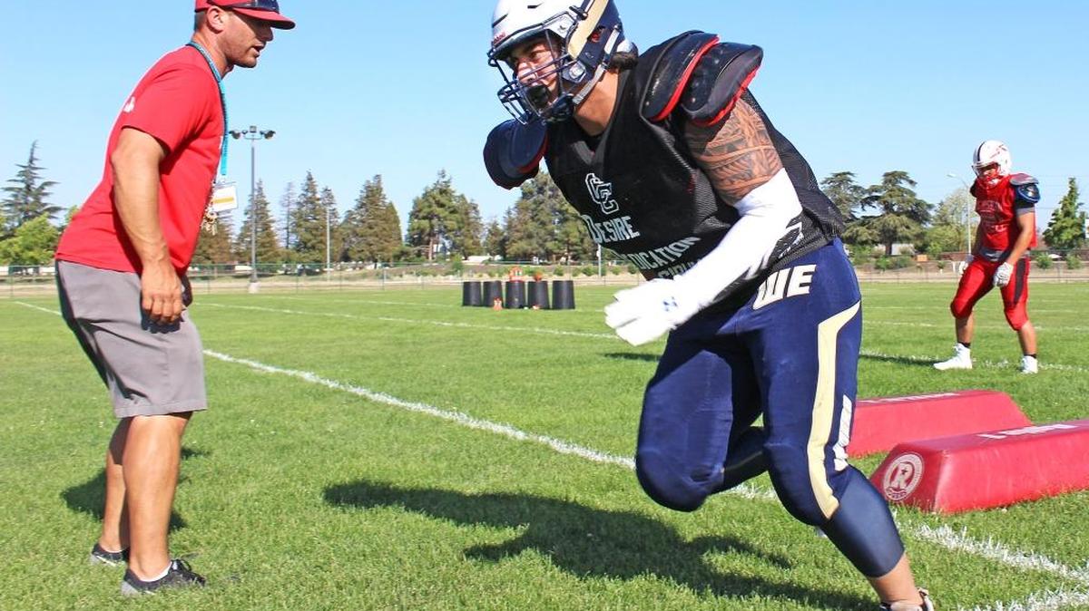 Patterson High football coach Rob Cozart watches former Central Catholic middle linebacker Kekupa’a Freehauf go through a position drill during the South’s practice at Stanislaus State on Monday, June 13, 2016. Freehauf will anchor the South’s defense during the 43rd annual Lions All-Star Football Classic on Saturday.