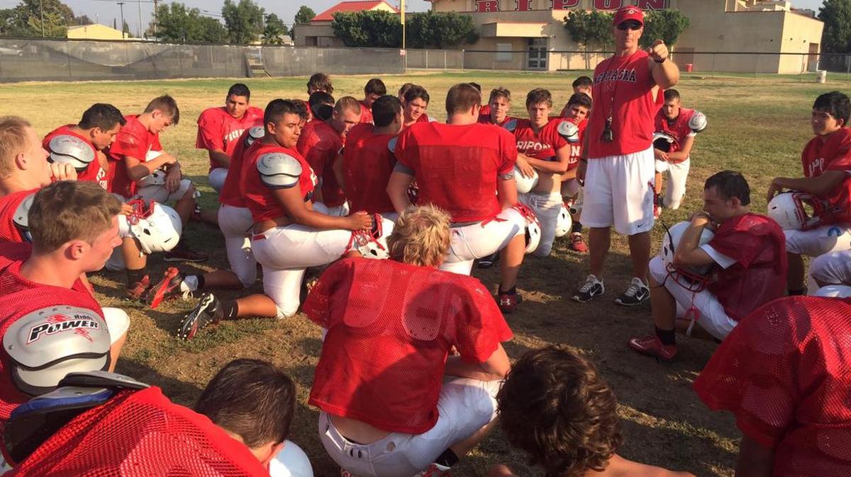 
Ripon High football coach Chris Johnson (center) speaks to his team following practice on Monday, Aug. 17, 2015. The Indians face a daunting nonconfernce schedule that includes trips Sierra, Patterson and home games against Sonora and Sutter.
