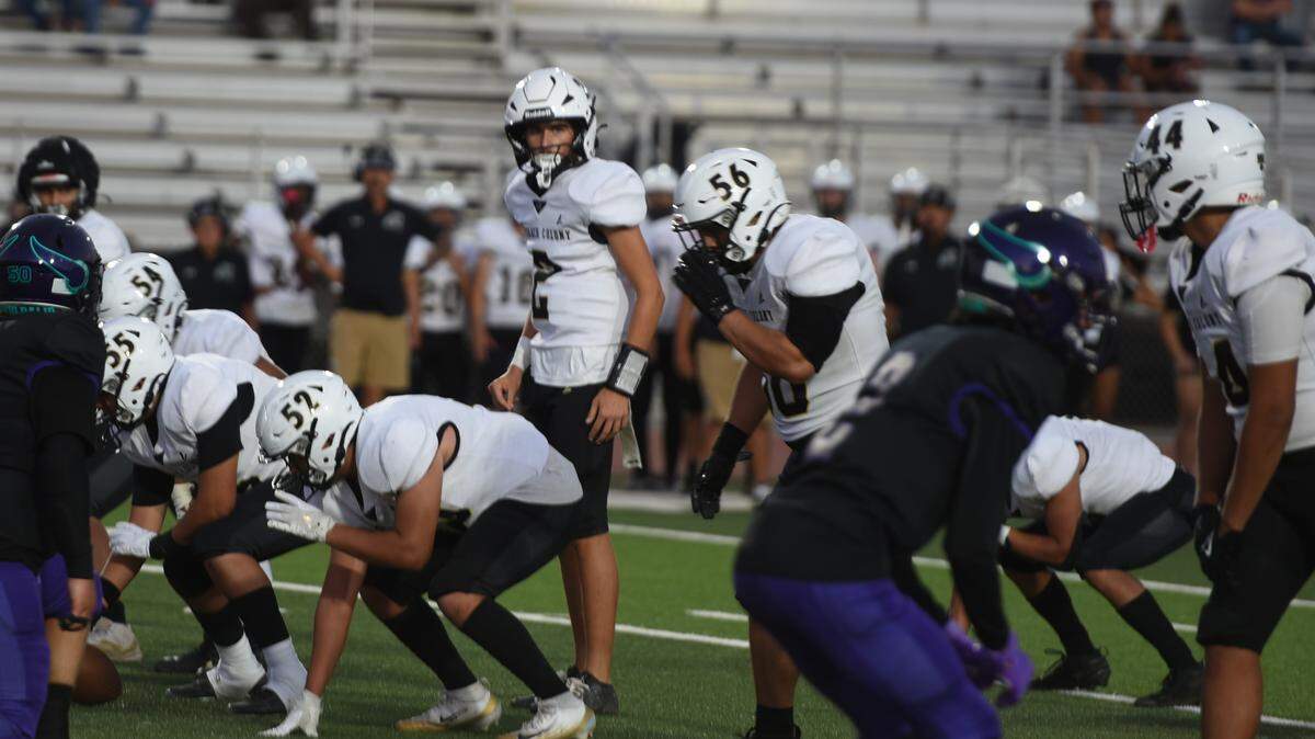 Buhach Colony quarterback Dayton Fitzgerald prepares to take a snap against Johansen in the first half on Friday, August 29, 2025.