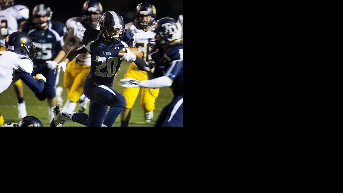 Downey's Jeffry  Jones (20) scores on a 25-yard pass  from P.J. Wilson in the first quarter of a Modesto Metro Conference game against Gregori on Friday night at Downey High School.