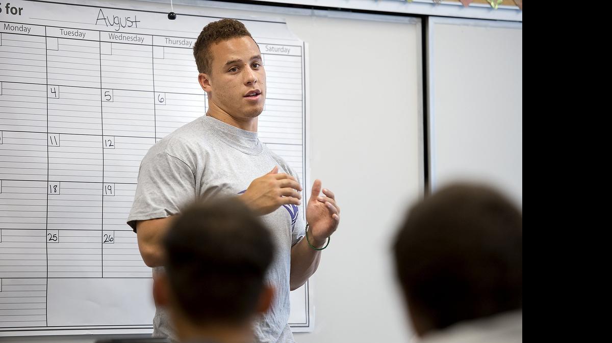 
San Francisco 49ers linebacker and former Stanford star Shayne Skov talks with Johansen football players after their morning workout in Modesto on Monday.
