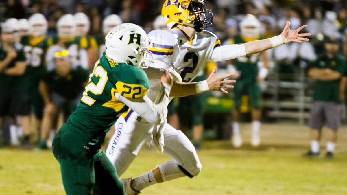 Escalon's Steven Grossi reaches for a pass that was a little to far out with Hilmar Highs Marcus Mouro (22) right behind him. Escalon High traveled to Hilmar for Friday night football Friday Oct. 6, 2017.