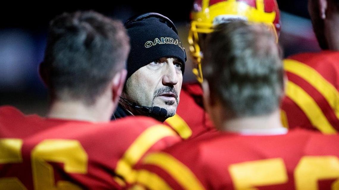 Oakdale coach Trent Merzon talks with players on the sideline during the Division III Sac-Joaquin Section final with Christian Brothers at Lincoln High School in Stockton, Calif., Friday, December 2, 2016.