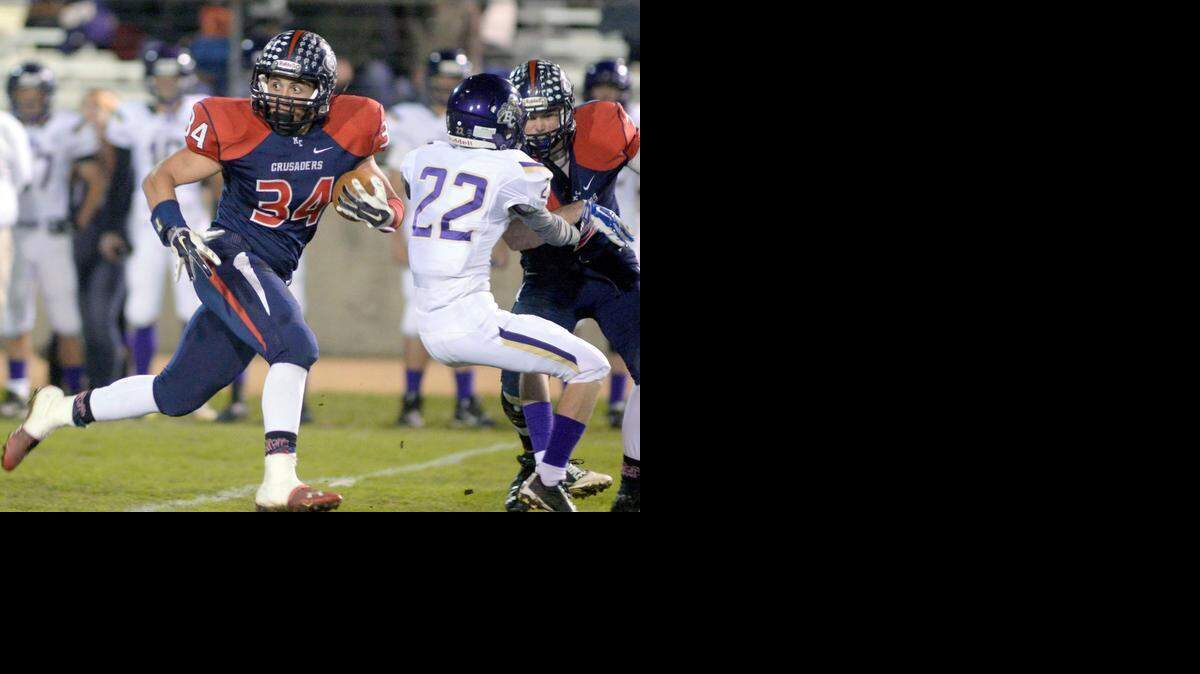 
Modesto Christian running back Zach Schott looks for defenders as he breaks off a 70 yard run during a Division VI Playoff game between Modesto Christian and Bradshaw Christian at Modesto Christian High School on Nov. 21, 2014.
