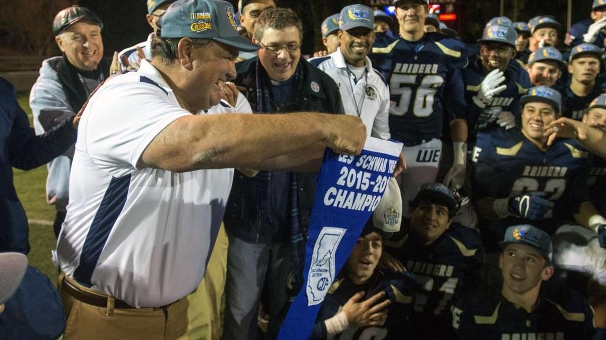 Central Catholic Head Coach Rodger Canepa holds the section banner after winning the Division III Championship game between Oakdale and Central Catholic, where Central Catholic won 21-7 at Lincoln High School in Stockton California on December 4, 2015.