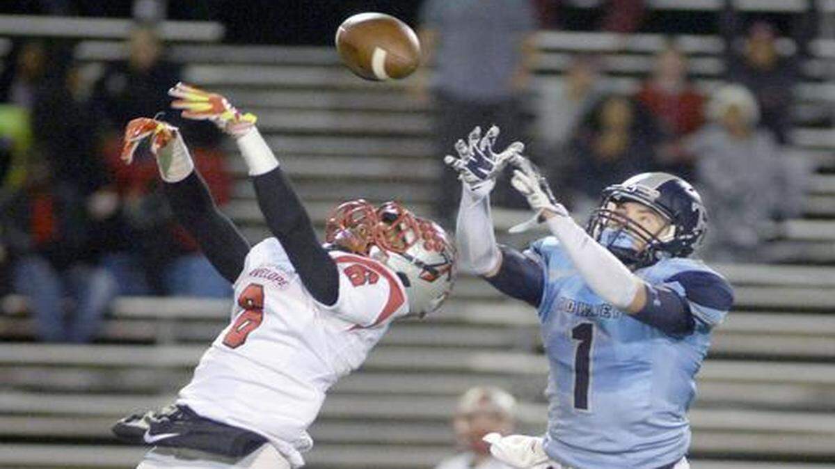
Downey wide receiver Josh Lowe, right, reaches over Antelope defender Davaeon Johnson during Friday night’s Sac-Joaquin Section Division II playoff game at Chuck Hughes Stadium. 

