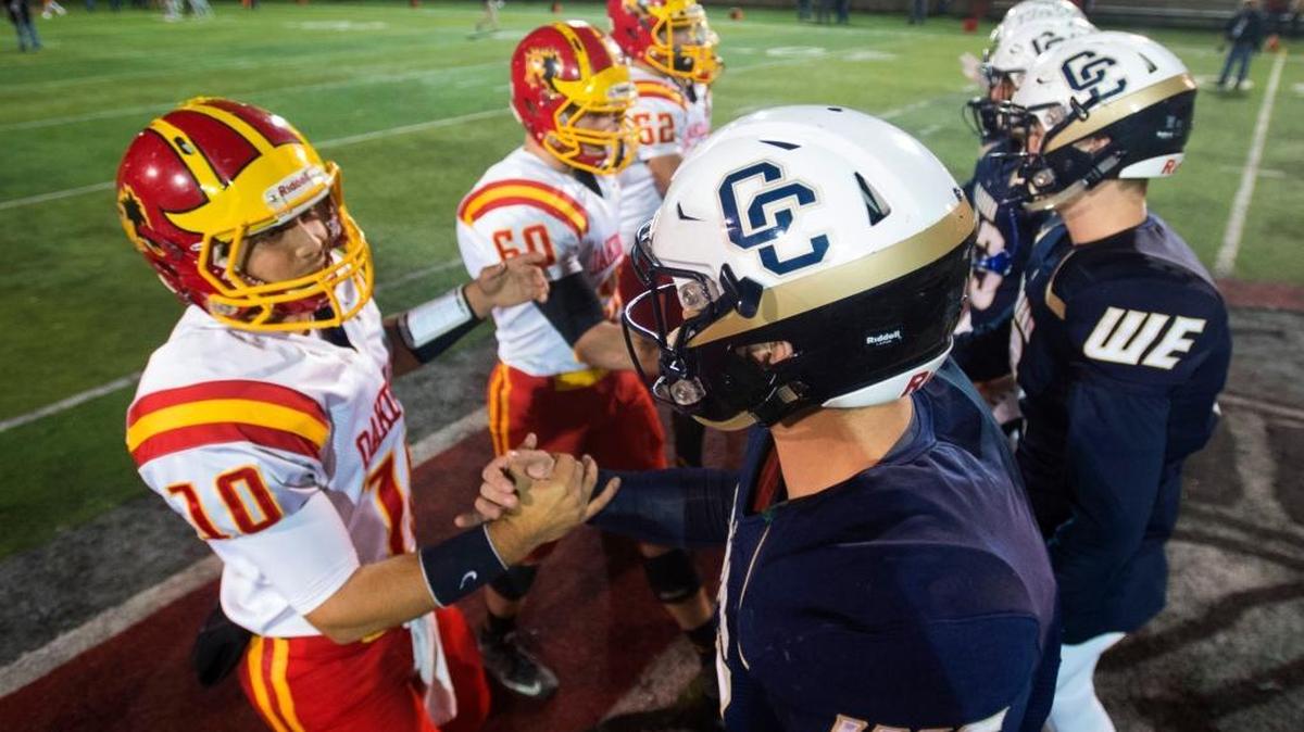 Central Catholic and Oakdale team captions meet at mid field during the Division III Championship game between Oakdale and Central Catholic, where Central Catholic won 21-7 at Lincoln High School in Stockton California on December 4, 2015.