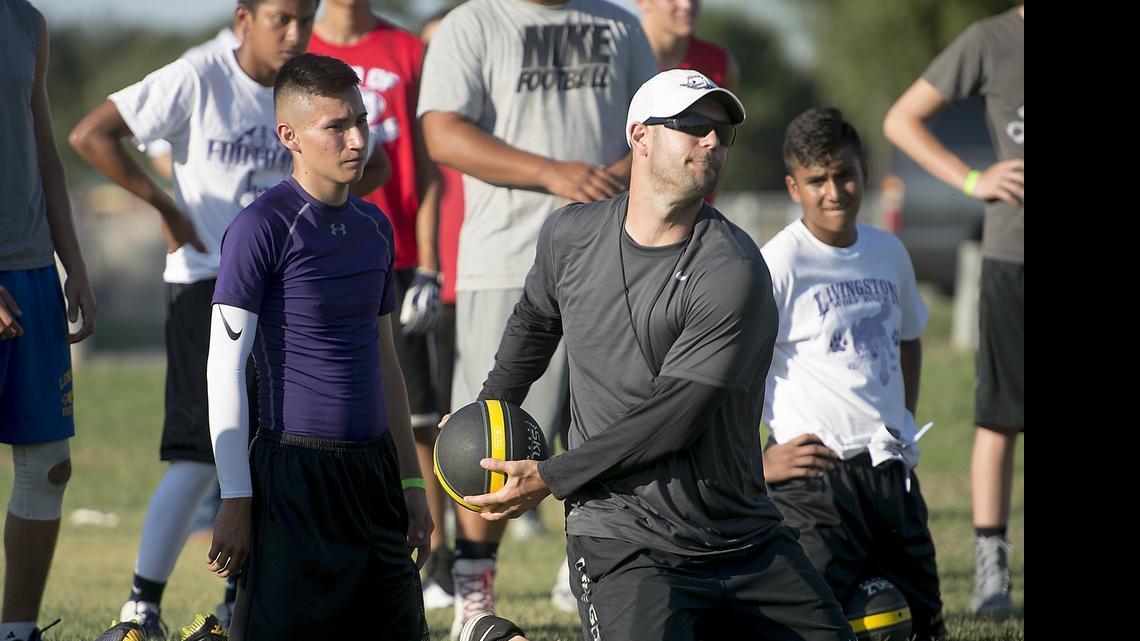 
Nate Costa demonstrates how to throw a heavy ball as he works out with quarterbacks during the Nate Costa Football Camp at Hilmar High School in Hilmar, Calif., on Wednesday, June, 24, 2015.
