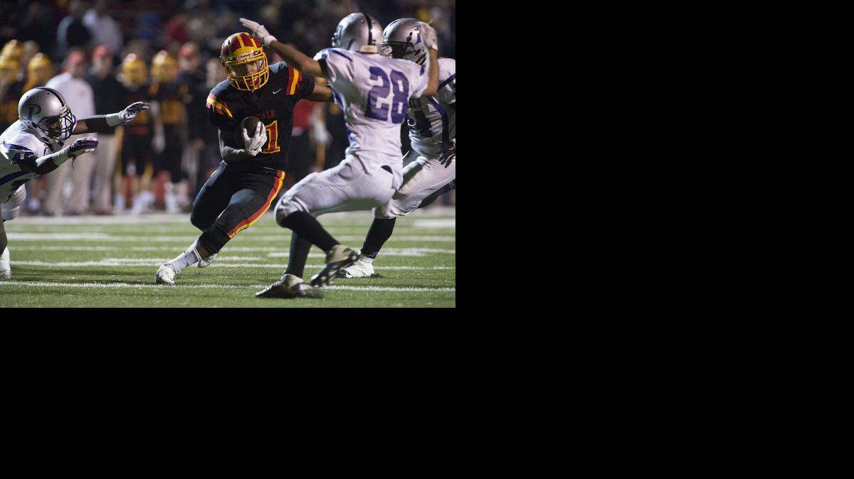 
Oakdale High’s Darus Nelson runs into a trio of Pacheco defenders and Pacheco in the Sac-Joaquin Section Division III playoff game in Oakdale, Calif., on Friday, November 14, 2014.
