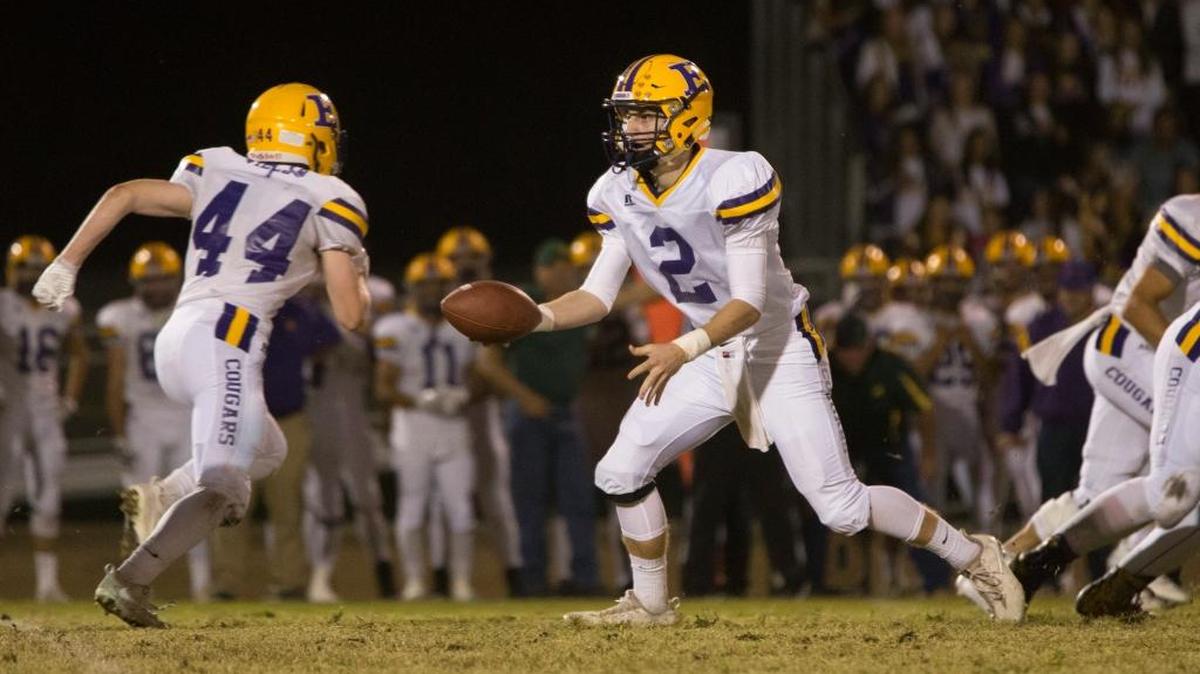 Escalon Highs quarterback Steven Grossi (2) hands off the ball to Elliott Mello (44) during the first half of play. Escalon High traveled to Hilmar for Friday night football Friday, Oct. 6, 2017.
