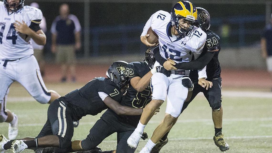 The Buhach Colony defense brings down Gregori junior quarterback Baker Melendez (12) during a game at Atwater High School in Atwater, Calif., on Friday, Aug. 17, 2018. The Thunder beat the Jaguars 13-6.