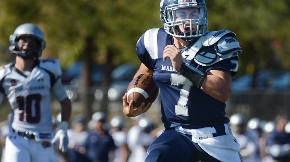 Marin Catholic quarterback Darius-James Peterson keeps the ball on a 75-yard touchdown run in a 26-8 win over Justin-Siena in Kentfield on Sept. 26, 2015.