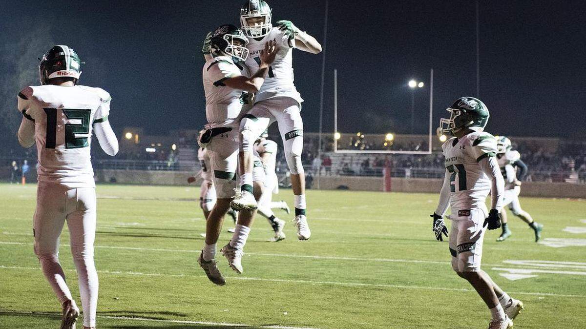 Manteca's Gino Campiotti and Jorge Cedano celebrate a touchdown during the Division III Sac-Joaquin Section championship game with Oakdale at Lincoln High School in Stockton, Calif., on Friday, Dec. 1, 2017.