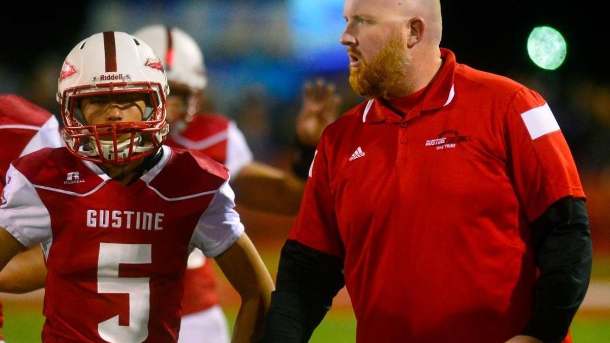 Gustine head coach Russell McWilliams talks to his team during a timeout during a game between the 9-0 Redskins and 9-0 Orestimba High. The Warriors won 21-13 to secure the Southern League title in Gustine, Calif., on Nov. 6, 2015.