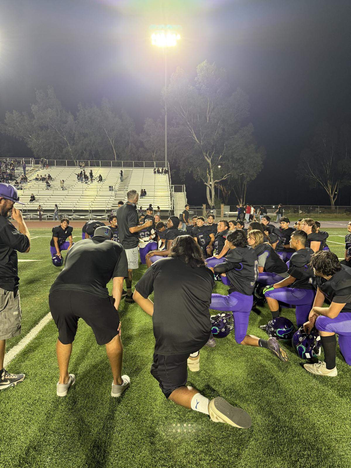 Johansen players gather after the game as head coach Rod Smith Sr. addresses the team following the 27-6 victory on Friday, Aug. 29, 2025.