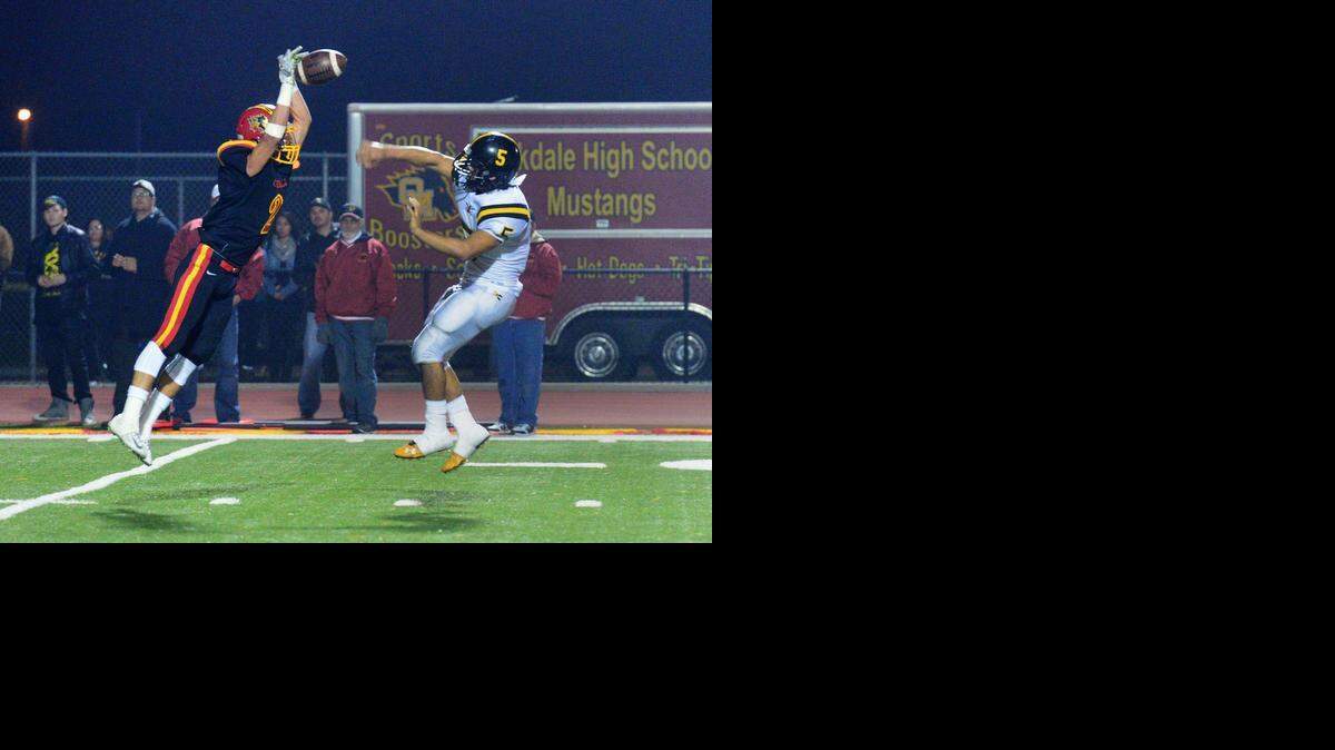 
Oakdale’s Tyler Flores, left, blocks a pass from Rio Linda’s James Sanchez on Friday night at The Corral. The host Mustangs beat the Knights 41-14.


