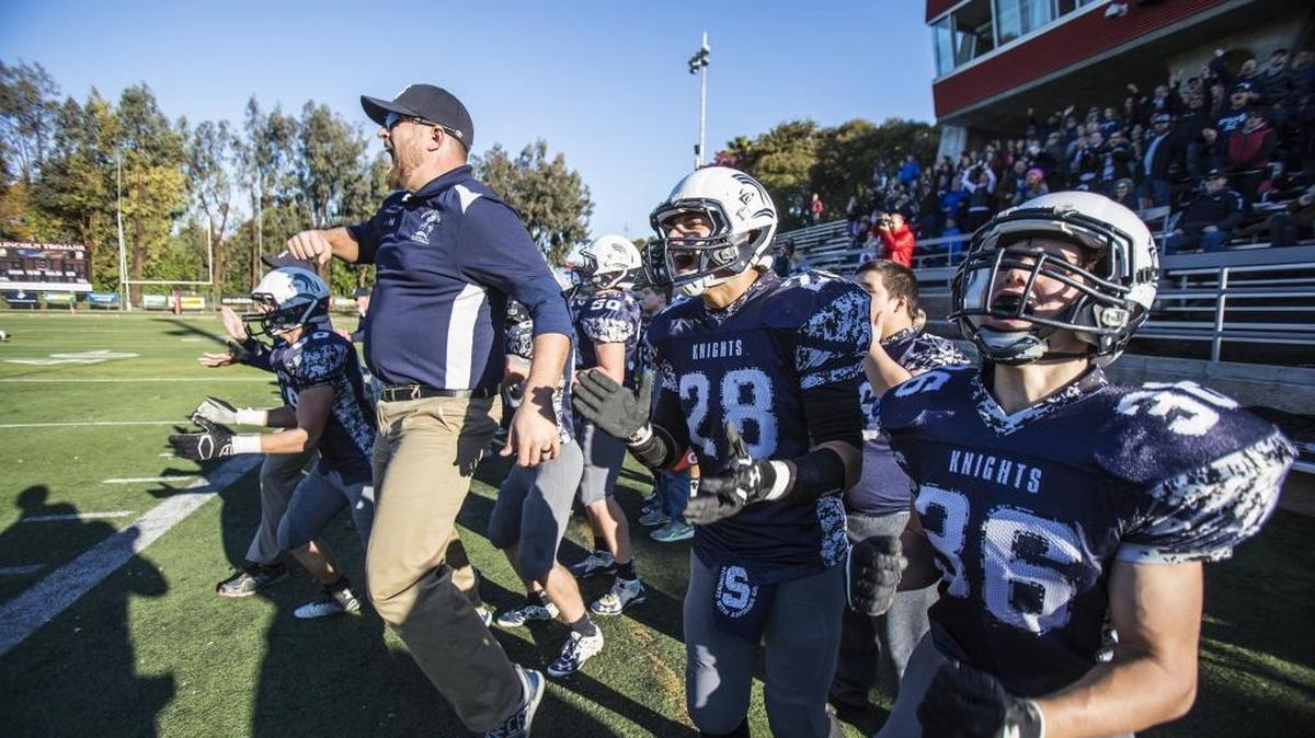 The Stone Ridge Christian bench celebrates as the final second tick down during the Sac-Joaquin Section Division VII championship against Big Valley Christian at Lincoln High School in Stockton, Calif., Saturday, Nov. 28, 2015. The Knights beat the Lions 69-0.
