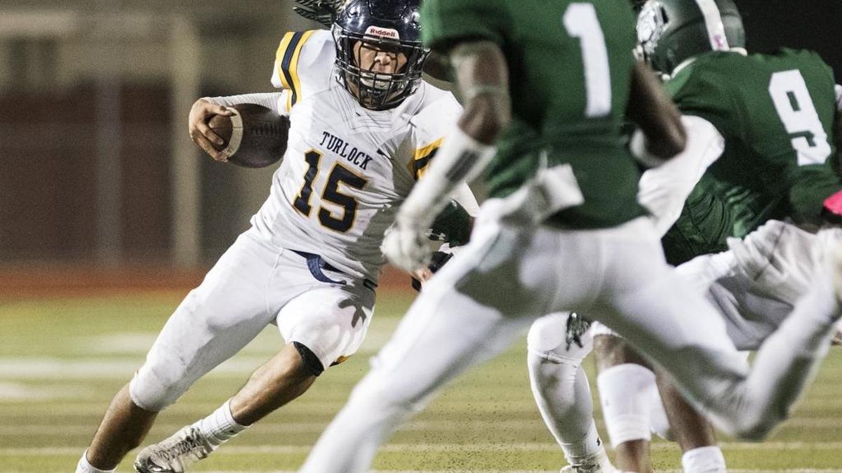 Turlock's Gabriel Cordero runs into a trio of Tracy defenders during the first round Division I Sac-Joaquin playoff game in Tracy, Calif., on Thursday, Nov. 9, 2017.