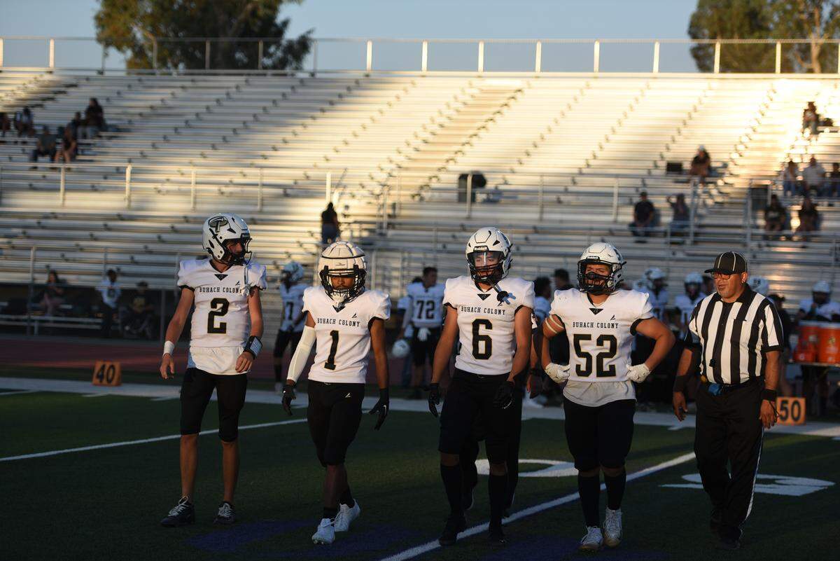 Buhach Colony football captains walk to midfield for the coin toss before Friday’s game against Johansen in Modesto on August 29, 2025.
