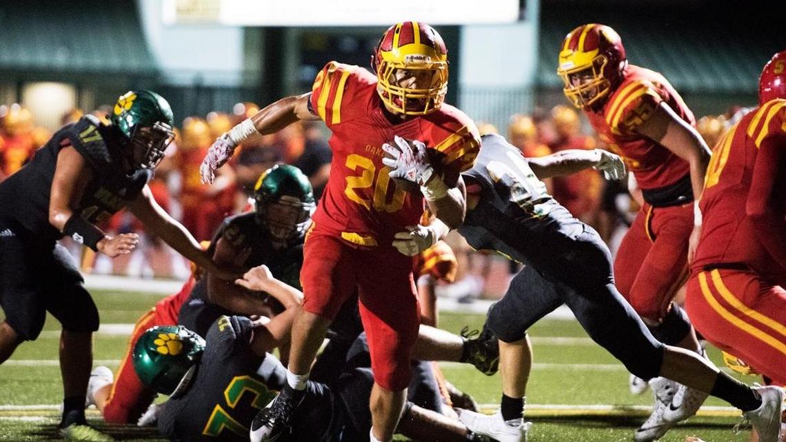 Oakdale runningback Cameron Cherry breaks through the Sonora defense for a touchdown during Friday nights game in Sonora, Calif., on Aug. 25, 2017. Oakdale won the game 47-13.