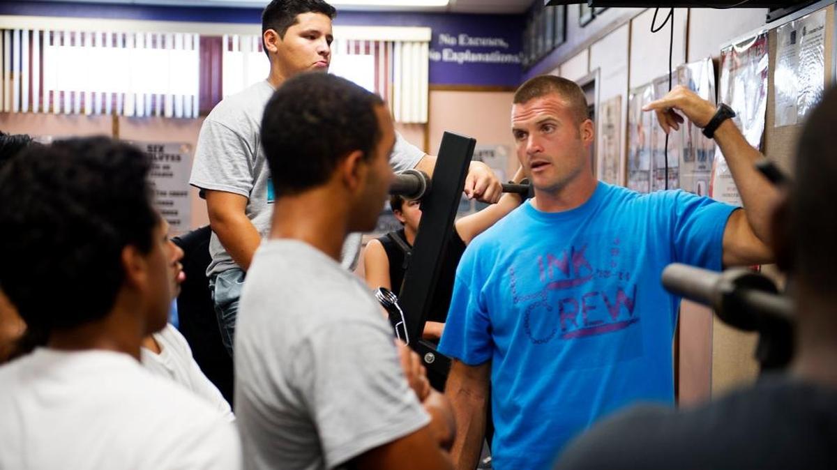 Strength and conditioning coach Scott Sacuskie breaks down the workout for members of the football team at Johansen High School in Modesto Calif., on Tuesday, August 12, 2014.