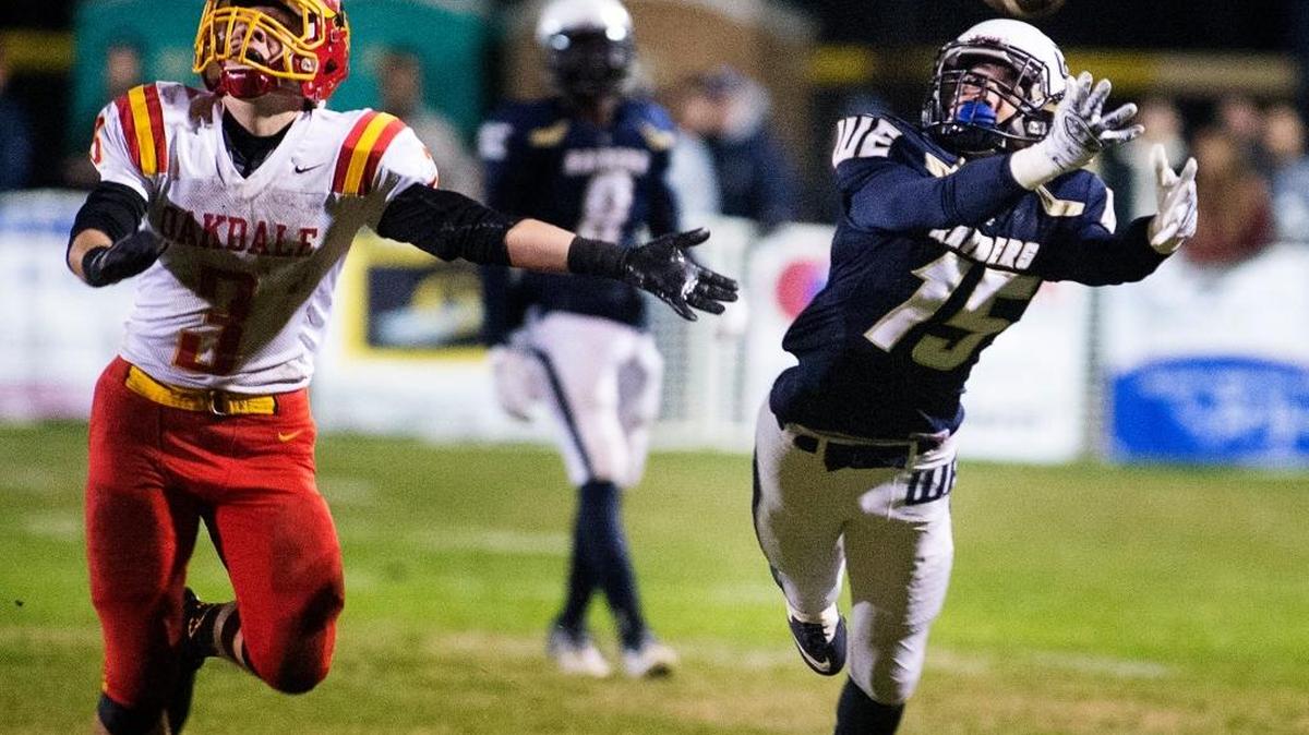 Central Catholic's Alex Padilla reaches for the Hunter Petlansky pass during the Valley Oak League game with Oakdale at Central Catholic High School in Modesto, Calif., on Friday, Nov. 6, 2015.