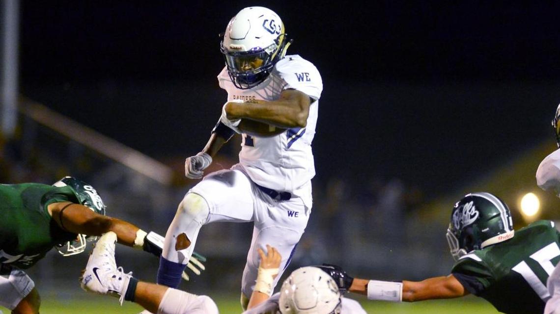 Central Catholic running back Dawaiian McNeely (7) leaps over a blocker during a game last season against Manteca.