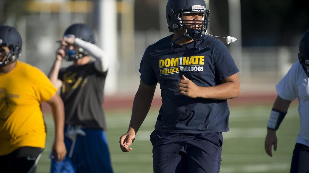 
Turlock linebacker Mustafa Noel-Johnson calls out as he leads the warmup before practice in Turlock, Calif., on Tuesday, August, 11, 2015.
