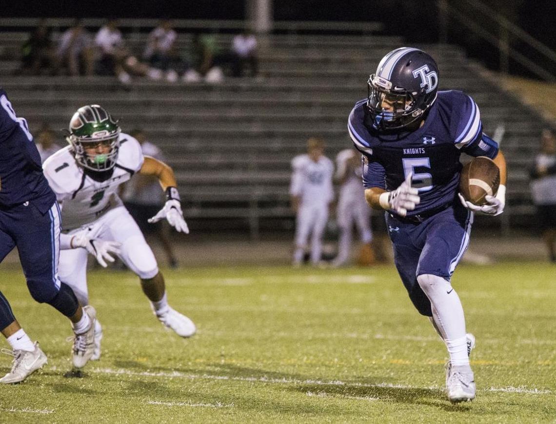 Downey High Ethan Difuntorum (5), playing defense, grabs an interception during a game last year against Pitman.