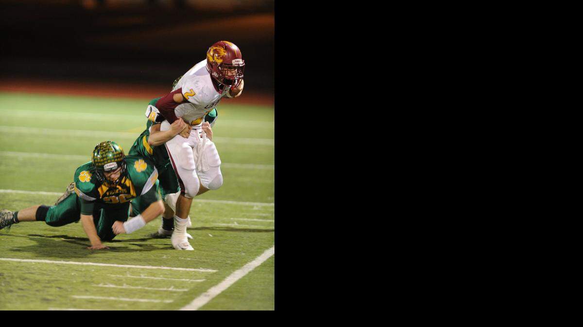 
Los Banos quarterback Adam Herrera looks to get out of bounds to stop the clock late in the second quarter Fri., Nov. 21 against Sonora High.
