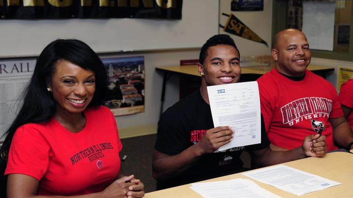 
McCoy Kent, a wrestler for Enochs High School in Modesto, CA. is pictured with his letter of intent to wrestle for Northern Illinois University on Tuesday afternoon (11-18-14) at the school. Also pictured are McCoy's mother and father Chante and Jules (right). 
