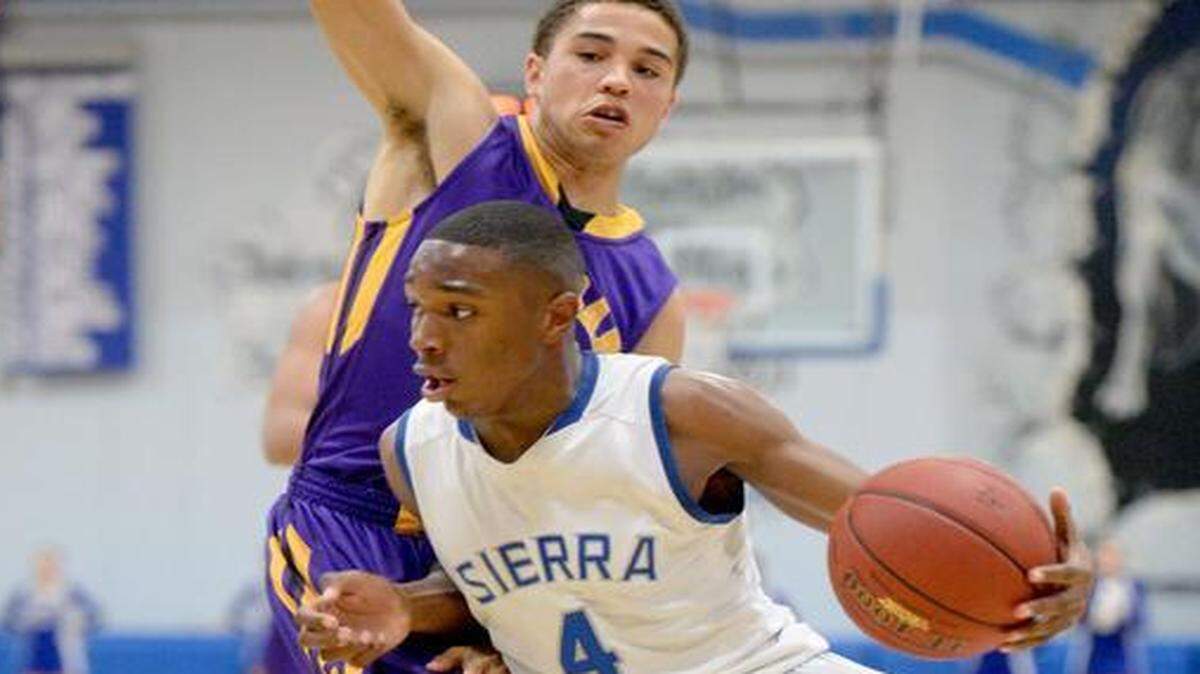 
Sierra guard Daniel Wyatt drives baseline past Archbishop Riordan's Max Randall during a CIF Division III Northern California boys basketball Regional game where Sierra defeated Archbishop Rirordan 65-57 at Sierra High School in Manteca on March 14th, 2015.
