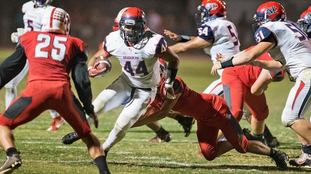 Modesto Christian's Paul Puaauli runs the ball during the Trans-Valley League game with Ripon in Ripon, Calif., on Friday, Oct. 23, 2015.