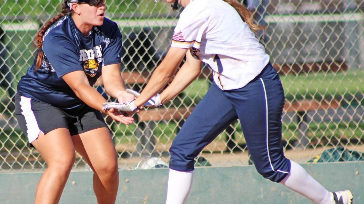 Gregori High coach Alannah Johns congratulates senior Madison Marsh after she belted a two-run home run in the third inning during a Sac-Joaquin Section Division I playoff game against Tracy High on Wednesday, May 25, 2016, at the Sacramento Softball Complex.