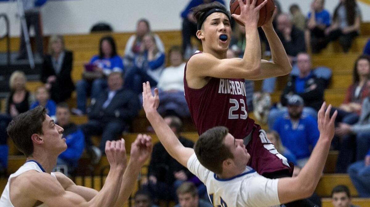 Riverbank's Christopher Certuche banks the ball off the backboard for a score during the Trans-Valley League game with Ripon Christian in Ripon, Calif., Friday, Jan. 6, 2017.