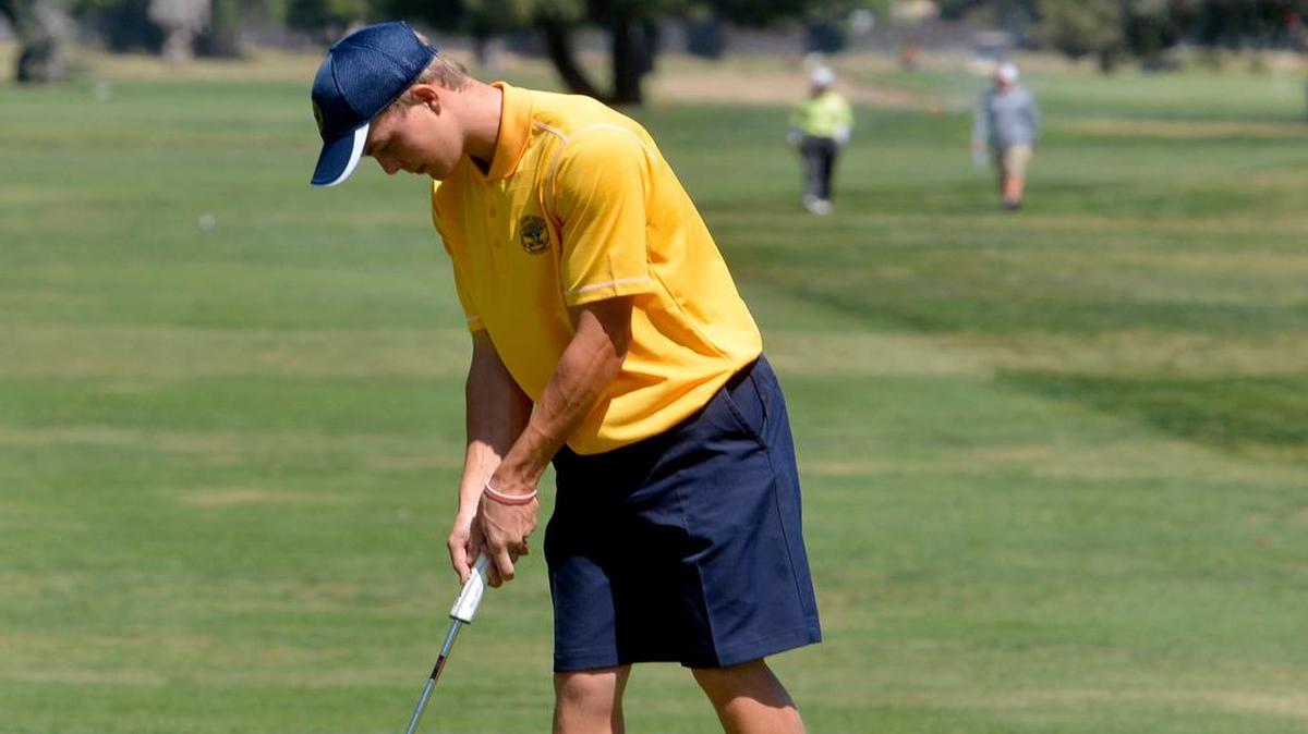 
Greg Jalli, 17, of Gregori High taps a putt into the hole to finish up the front 9 holes during the Sac-Joaquin Section Division 1 South Golf Tournament on Monday (5-4-15) at Rancho Del Rey golf course in Atwater. 
